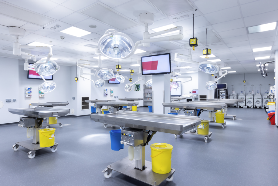 a surgical room with operating tables and lights